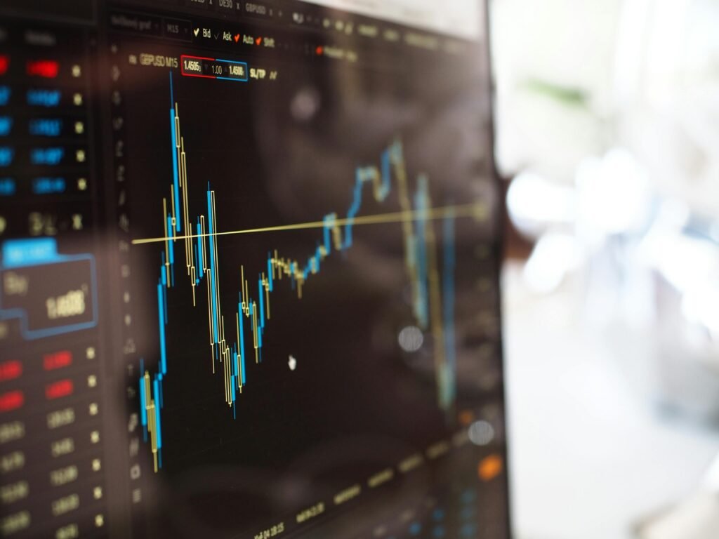 Detailed view of financial trading graphs on a monitor, illustrating stock market trends.